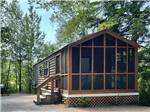 Large cabin surrounded by trees at CLEARWATER CAMPGROUND - thumbnail