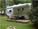 View larger image of A deck next to a trailer at BONNIE BRAE CABINS  CAMPSITES image #2