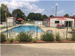 View larger image of View of the pool and buildings nearby at CADDO VALLEY RV PARK image #2