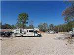 View larger image of RV on a gravel road with blue skies at CADDO VALLEY RV PARK image #6