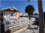 A row of colorful rental cabins at CAMPING ON THE GULF - thumbnail