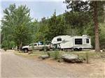 Fifth-wheel and tow vehicle in campsite at CAMPGROUND ST REGIS - thumbnail