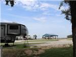 Fifth-wheel with canopy, blue sky background at COVERED WAGON RV RESORT - thumbnail
