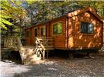 A wooden cabin with a deck at PIONEER CAMPGROUND - thumbnail