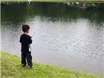A small boy fishing in the lake at EVERGREEN LAKE PARK - thumbnail