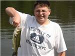 A boy holding a fish at EVERGREEN LAKE PARK - thumbnail