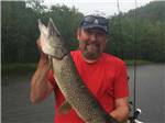 View larger image of A man holding a fish at SID TURCOTTE PARK CAMPING AND COTTAGE RESORT image #12