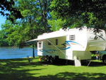 RV parked at site by the water - thumbnail