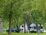 RV site among the trees - thumbnail