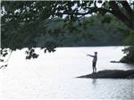 View larger image of A lone man fishing in the lake at LAKE PEMAQUID CAMPGROUND image #4