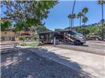 RV and trailer parked by a paved site - thumbnail
