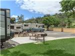 RVs parked near grill and picnic tables - thumbnail