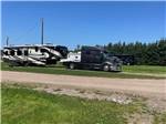 A diesel truck and a fifth wheel in a gravel site at SCOTIA PINE CAMPGROUND - thumbnail