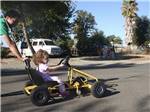 Girl riding a mini go-kart at SAC-WEST RV PARK AND CAMPGROUND - thumbnail