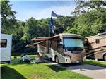 A motorhome in a back in RV site at ELKHORN CREEK RV PARK - thumbnail