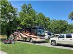 A motorhome and truck in a RV site at ELKHORN CREEK RV PARK - thumbnail