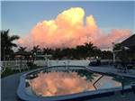 Vanilla sky being reflected on glassy community pool at BONITA LAKE RV RESORT - thumbnail