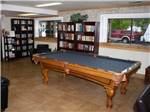 The pool table with bookshelves at MOUNTAIN SHADOWS RV PARK & MHP - thumbnail