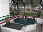 The inside hot tub under glass at MOUNTAIN SHADOWS RV PARK & MHP - thumbnail