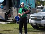 View larger image of Man playing bagpipes at SUN N SHADE RV RESORT image #8