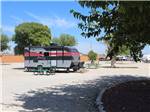 A red and black travel trailer in a RV site at CARLSBAD RV PARK & CAMPGROUND - thumbnail