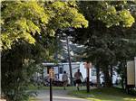 A couple walking by shaded RV sites - thumbnail