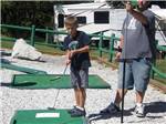 View larger image of Man and boy playing mini golf at LONE PINE CAMPSITES image #3