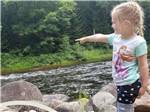 View larger image of A little girl pointing to at the water at SINGING WATERS CAMPGROUND image #12