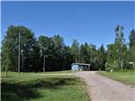 Dirt road leading to RV sites at STILLWATER TENT & RV PARK - thumbnail