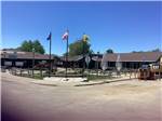 Three flags in front of Showhall Town Square at RED TRAIL CAMPGROUND - thumbnail