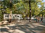 People walking in the road past RV sites - thumbnail