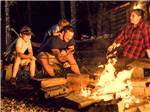 A family around a fire at night - thumbnail