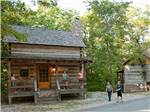 People on the porch of a rustic cabin - thumbnail