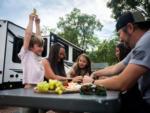 Family playing a card game at GARDEN OF THE GODS RV RESORT - thumbnail