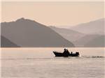 View larger image of Two people fishing from a boat at CACHUMA LAKE CAMPGROUND image #2