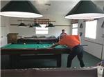 View larger image of A man in an orange shirt playing pool at MCALLEN MOBILE PARK image #12