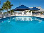 View larger image of The aquamarine waters of a pool reflect a covered patio at BIG PINE KEY RESORT image #2