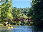View larger image of A bridge over the water at CAMP TOODIK FAMILY CAMPGROUND CABINS  CANOE LIVERY image #12