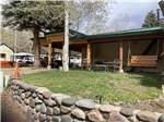 Stone wall in front of building at Pagosa Riverside Campground - thumbnail