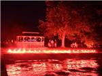 The gazebo at night with red lights at THE "WILLOWS" ON THE LAKE RV PARK & RESORT - thumbnail