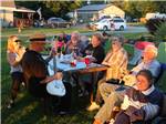 A group of people listening to a guitar at THE "WILLOWS" ON THE LAKE RV PARK & RESORT - thumbnail