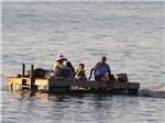 A group of people on a motorized swimming dock at THE "WILLOWS" ON THE LAKE RV PARK & RESORT - thumbnail