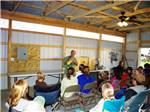 A group of people listening to a man holding a bird at THE "WILLOWS" ON THE LAKE RV PARK & RESORT - thumbnail