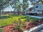 A fifth wheel trailer parked in a shady site at VACATIONER RV PARK - thumbnail