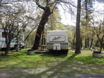 Trailer at grassy site at Antlers Resort & RV Park - thumbnail