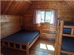 The beds inside of the cabin at DIXIE FOREST RV RESORT BY RJOURNEY - thumbnail