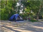 A blue tent with a picnic bench at CEDAR CITY RV RESORT BY RJOURNEY - thumbnail