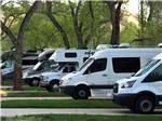 A row of motorhomes in paved sites at CEDAR CITY RV RESORT BY RJOURNEY - thumbnail