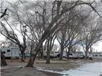 Motorhomes parked with snow on the ground at CEDAR CITY RV RESORT BY RJOURNEY - thumbnail