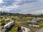 View larger image of A group of RVs in sites at REDWOOD COAST CABINS  RV RESORT image #7